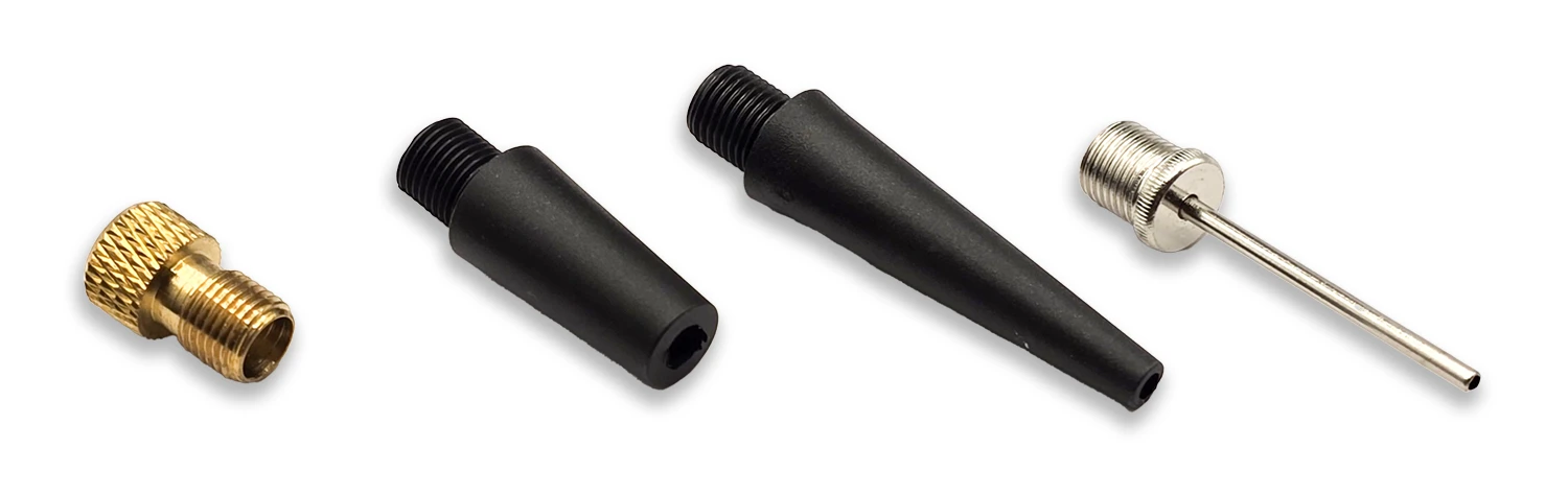 The four bundled Skight adapters: a brass Presta valve adapter, two tapered nozzles, and a ball needle