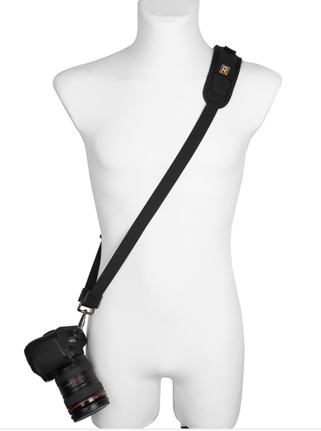 Danger Buddies sling strap worn across the body, with a DSLR hanging at hip level