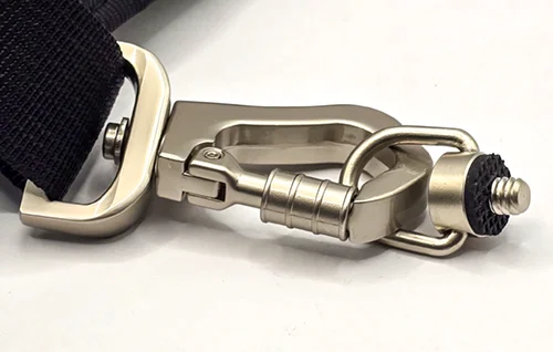 Close-up of the Danger Buddies locking carabiner, stainless swivel, and tripod-mount screw