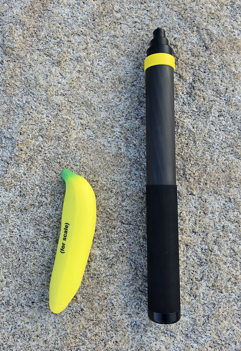 The Insta360 selfie stick fully collapsed, next to a banana for scale