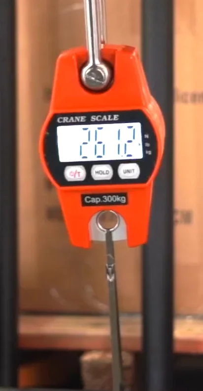 Crane scale reading 261 pounds before a stainless steel zip tie breaks