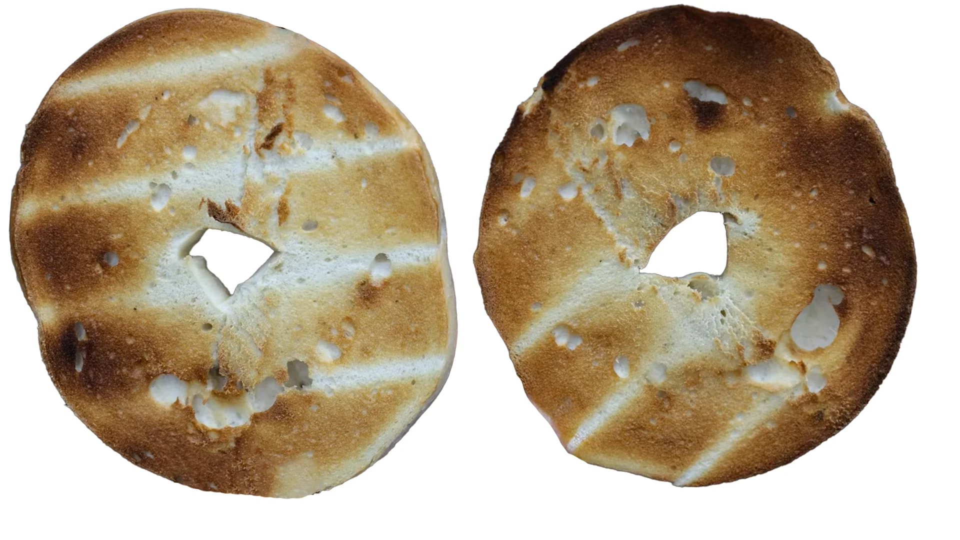Two bagel halves toasted in the GE toaster, with patchy, uneven browning