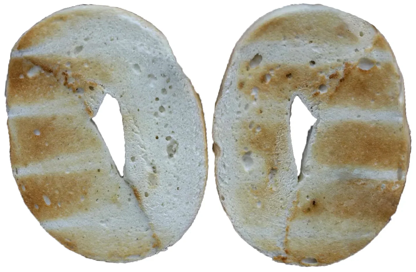 Two bagel halves toasted in the Revolution toaster, evenly and consistently browned